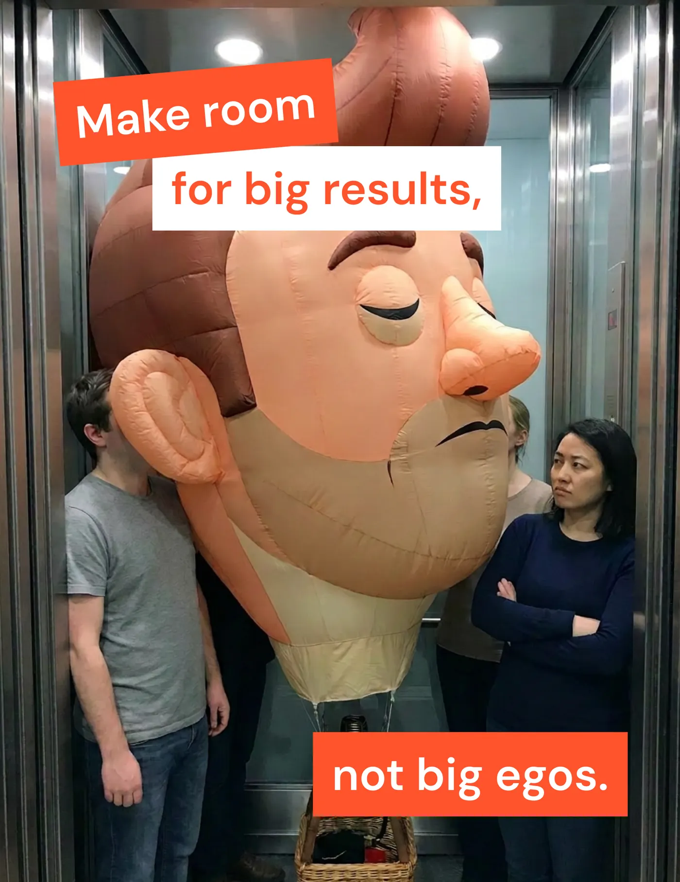 Three people squeezed into a lift beside a giant inflatable head, captioned &ldquo;Make room for big results, not big egos.&rdquo;